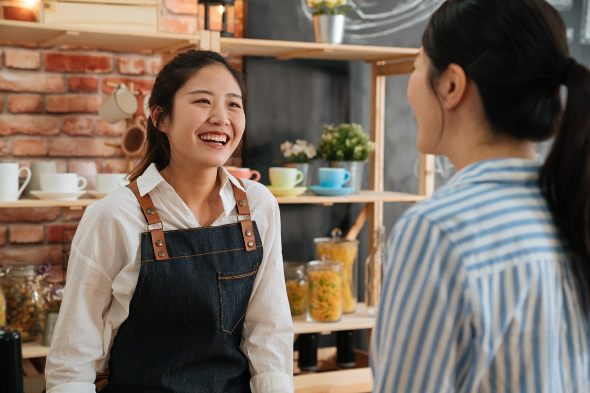 Happy Waitress Talking to a Customer